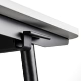 Close-up of modern sit-stand desk edge, showcasing sleek design and quality materials.