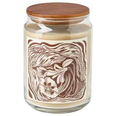 A GLANSLIND scented candle in a clear glass jar with a wooden lid. The label has a brown and beige floral design. The candles color is beige.