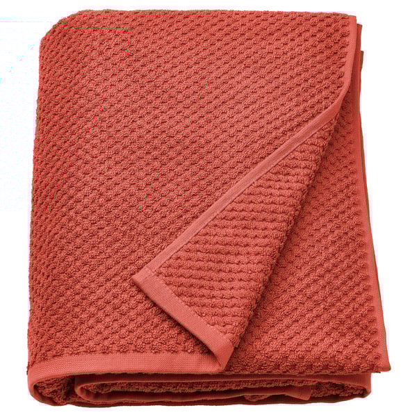 Folded orange GULVIAL towel, 100% cotton, textured surface.
