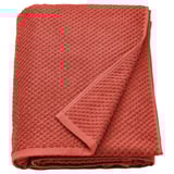 Folded orange GULVIAL towel, 100% cotton, textured surface.