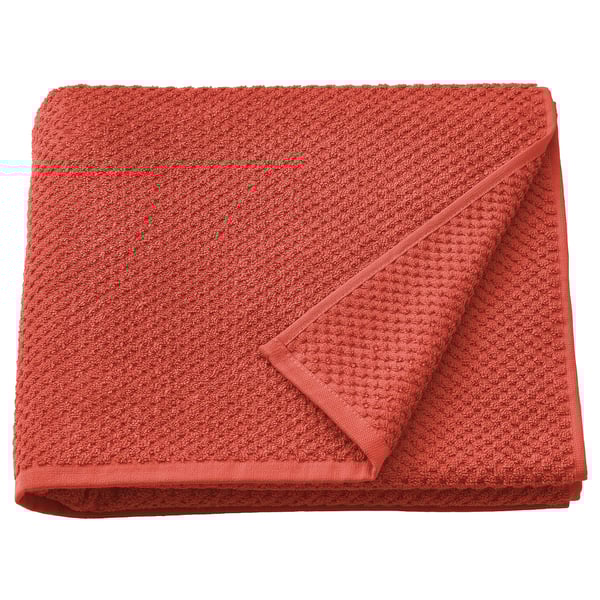 A folded, bright orange GULVIAL towel made of 100% cotton, featuring a soft and textured design.