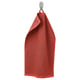 A red towel named GULVIAL hangs on a hook. Made from 100% cotton, its soft, absorbent, and fluffy. The towel is rectangular and a terry texture.
