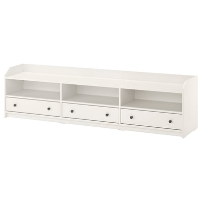 An IKEA HAUGA white tv bench with three drawers and open compartments, designed for home use, offering both storage and cable management.