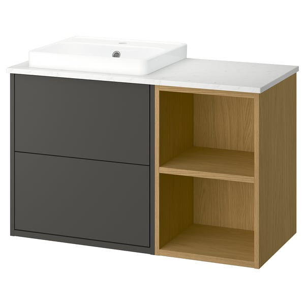 A modern bathroom vanity named HAVBÄCK in dark grey and light oak, featuring a marble countertop, a white ceramic sink, two drawers, and open shelves.