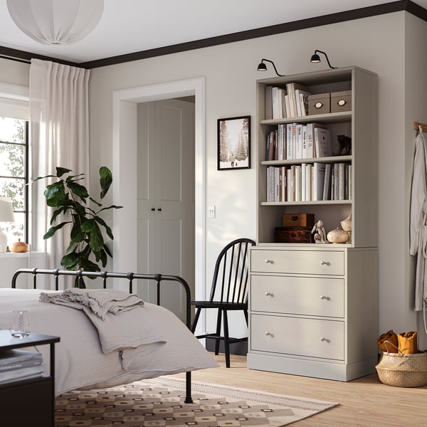 Modern bedroom with HAVSTA grey chest & bookshelf, aligned shelves.