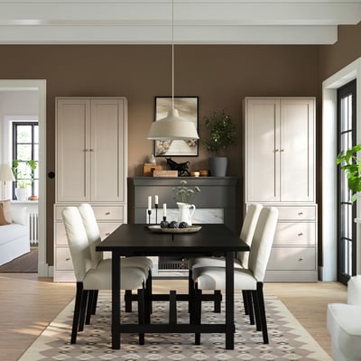 Small, light-colored HAVSTA chest of drawers fits neatly between two tall units in modern dining room.