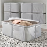 Storage box with lid, holding folded clothes, stacked neatly for organized storage.