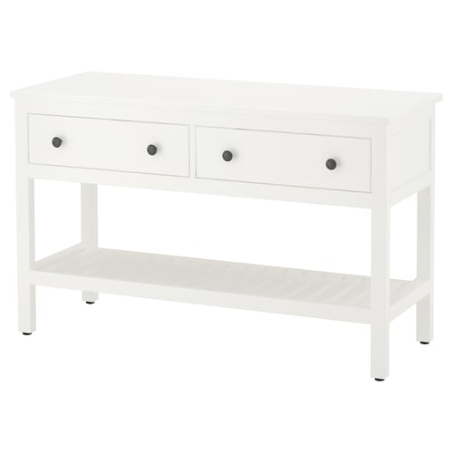 A white HEMNES console table. It has three drawers with silver knobs and an open shelf. The design is simple and functional.