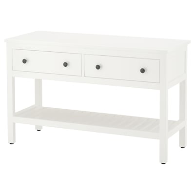 A white HEMNES console table. It has three drawers with silver knobs and an open shelf. The design is simple and functional.