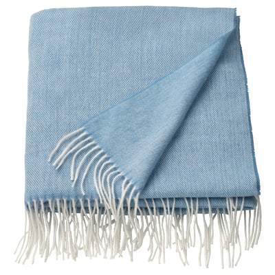 Light blue, rectangular blanket with fringe edges, soft and recycled polyester.