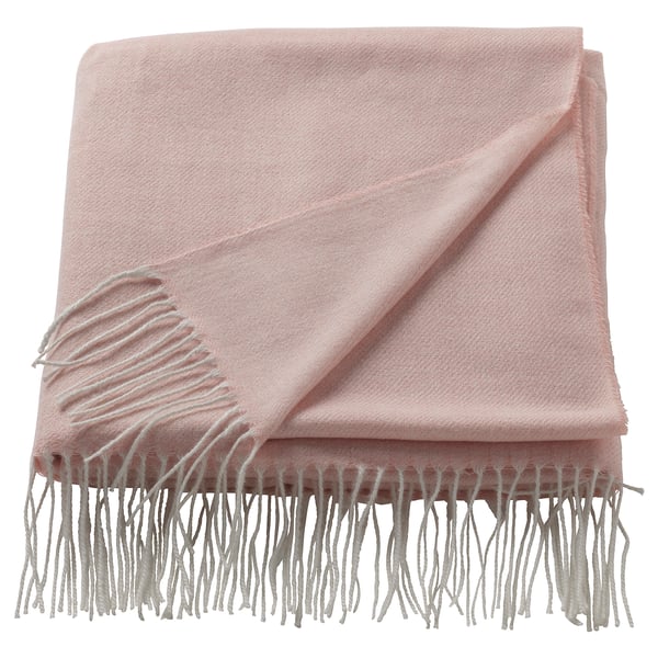 Light pink HOLMVI throw blanket, soft, rectangular with fringe edges, made from recycled polyester.