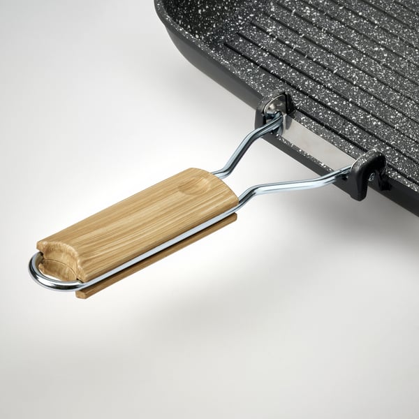 Black grill pan with wooden handle, silver accents, speckled non-stick surface.