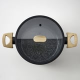 Black skillet with wooden handles and glass lid, showcasing high-quality ceramic non-stick coating.