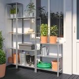 Gray HYLLIS outdoor shelving unit with plants, tools, and boots.