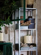 Silver HYLLIS shelving with mesh compartments, holding plants and decor, indoor/outdoor use.