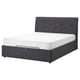 Dark gray upholstered bed with tufted headboard and white mattress.