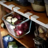 Glass container storing beets and garlic, part of IKEA 365+, organizes kitchen items neatly.