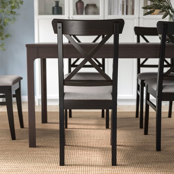 Dining set with dark wood chairs and cushioned seats, ideal for long meals and chats.