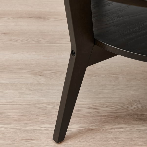 Modern coffee table with dark wood finish. Sleek, sturdy legs and a circular top. Designed for durability and style.