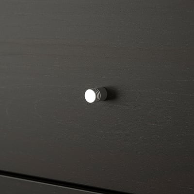 Close-up of a sleek, black KALLAX drawer handle; modern and minimalist design.