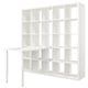 White KALLAX shelving unit with adjustable table and mix of open/closed storage.