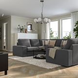 Modern living room with KIVIK sofa, wooden floors, and large windows.