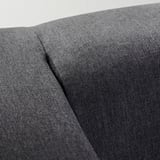 Close-up: modern sofa in dark gray fabric, showcasing smooth texture and neat stitching.