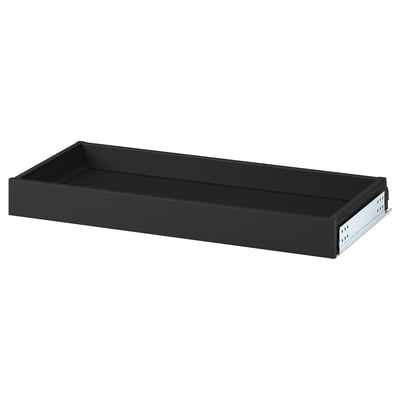 Black steel drawer, handle-free, smooth action.