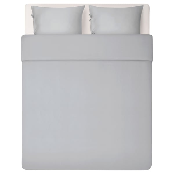 Image shows a neatly made grey bed with smooth, silky grey bedding set, including duvet cover and two pillowcases, depicting modern minimalist design.
