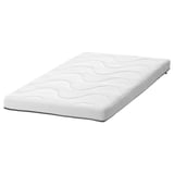 A white KRUMMELUR cot mattress by ikea, rectangular with wavy and smooth sides, and a zippered, washable cover.
