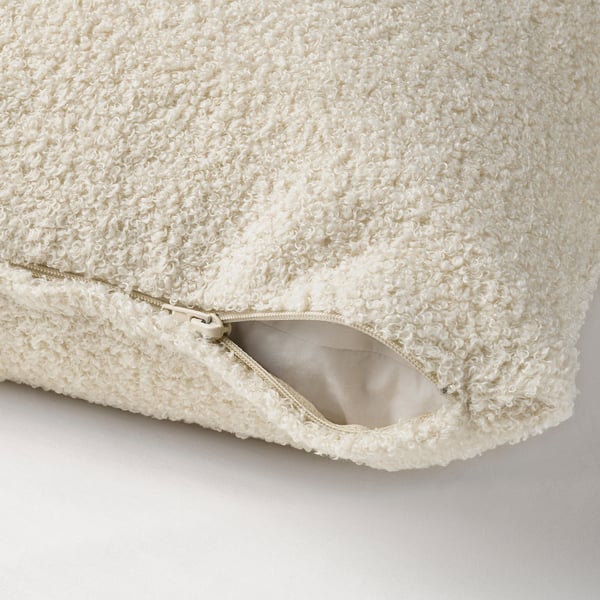 Light beige cushion cover with soft teddy-like pile; zip for easy washing.