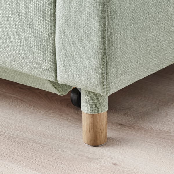 Close-up of a modern sofas wooden leg, showing quality craftsmanship and design.
