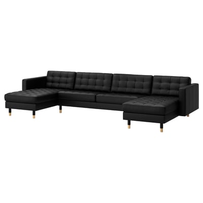 Black l-shaped leather sofa, modern, tufted cushions, wooden feet.