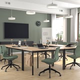 Modern office with LÅNGFJÄLL chairs, green & light wood. Large tv, plants, & natural light.