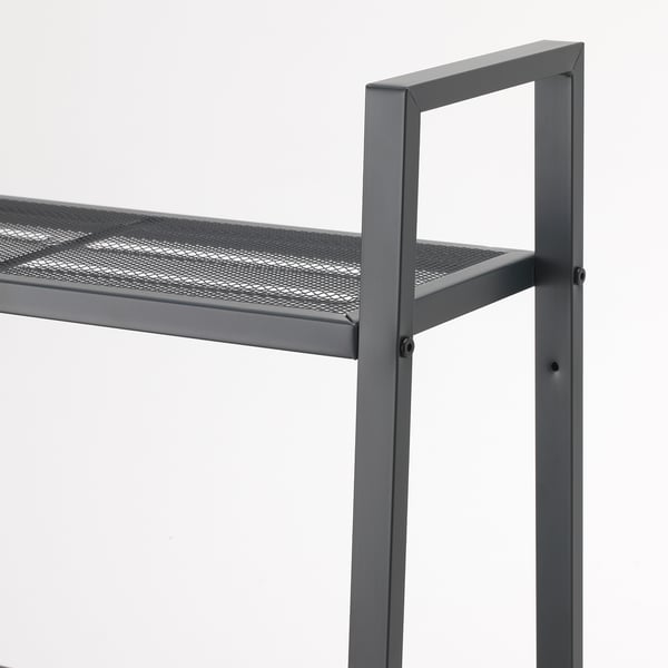 A high-quality metal shelf with a mesh-like top surface, supported by sturdy vertical beams with visible screws ensuring stability.
