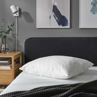 Cozy bedroom with LÖKSTAMFLY pillow, art & bedside plant.