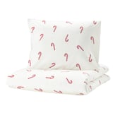 White duvet set with red candy cane print, soft cotton, holiday-themed.