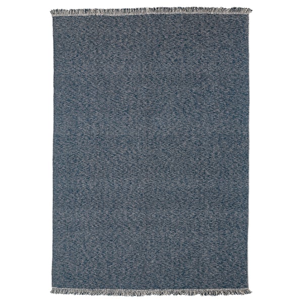 Dark blue rectangular cotton rug with herringbone pattern and fringed ends.