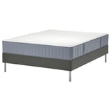 A modern grey bed with a supportive mattress, designed for comfort and stability.