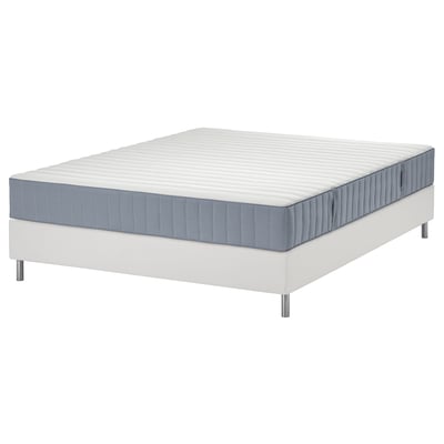Pristine white mattress set on modern base. Quilted grey edges, pocket springs for comfort.