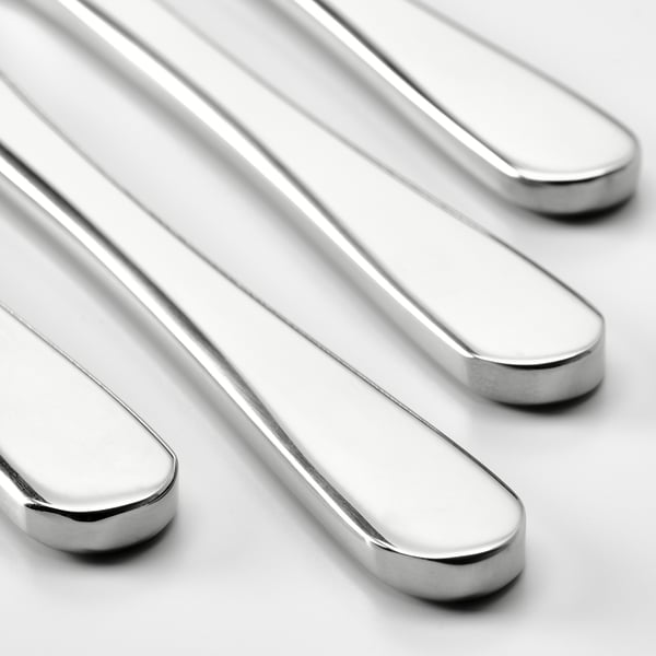 Four sleek, polished stainless-steel knives arranged neatly in a row, showcasing their sharp, reflective blades.
