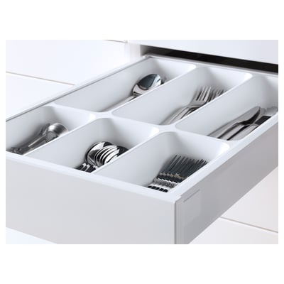 White drawer organizer with compartments holding cutlery, pulled out fully for easy access.