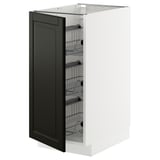 A white METOD kitchen cabinet with a black bodbyn door, featuring pull-out wire baskets.