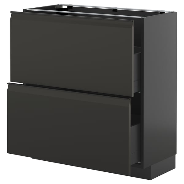 A modern black METOD kitchen cabinet with sleek handles and a high drawer.