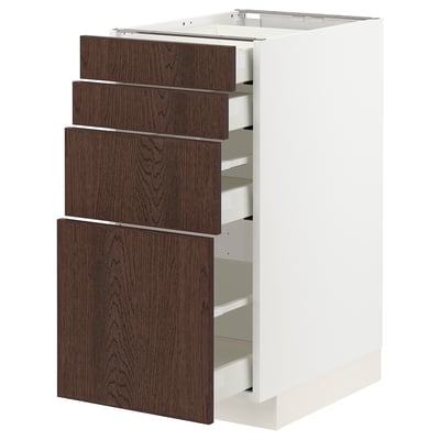 Modern white METOD kitchen unit with dark brown wooden drawers and oak veneer.