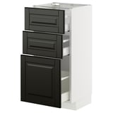White METOD kitchen cabinet with black drawers and door, beveled edges, glass shelf.