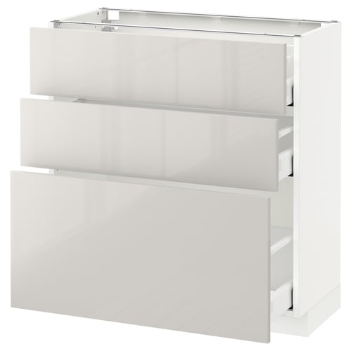 Depicts a white METOD kitchen cabinet with high gloss finish and multiple drawers.