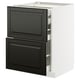 An ikea METOD kitchen unit. It is white with black bodbyn drawers, featuring a sleek, modern design.