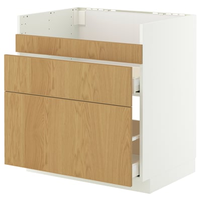 A white and light oak METOD cabinet with drawers and shelves. Its a kitchen unit with a sleek, modern design.