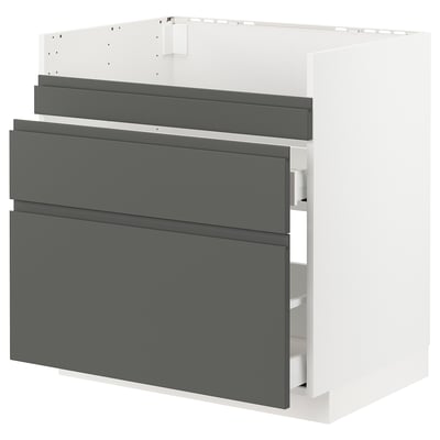 Modern grey kitchen cabinet with integrated handles, flat design.